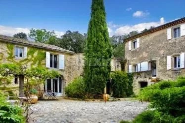 Ref 68144FC: In a charming hamlet near Saint Paul Trois châteaux, property dating from 1865 on wooded land of 2086 m2. Organized around a majestic, paved courtyard, these 2 stone houses have managed to preserve the magic of ancient times. They will o...