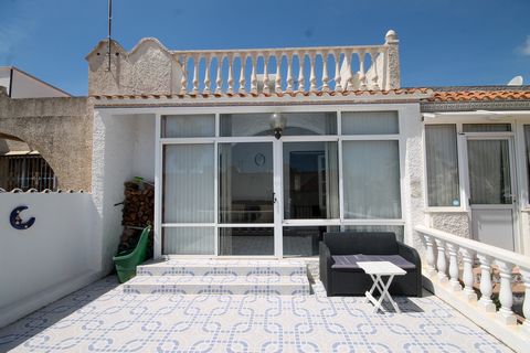 Situated in the popular urbanisation of Blue Lagoon, just outside Villamartin, we offer this well presented mid terrace house. It comprises of an enclosed terrace with log burner which makes a cosy lounge area looking out onto the patio. This room le...