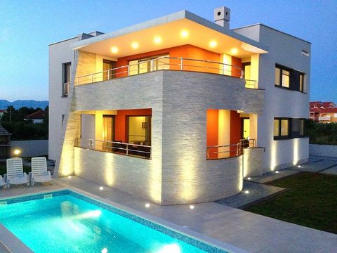 Beautiful modern villa with its own private pool is located in a small and quiet place in the vicinity of Zadar. The villa extends on 380 sqm of living space, with 798 sqm of garden. On the ground floor of the villa there is a spacious living room wi...