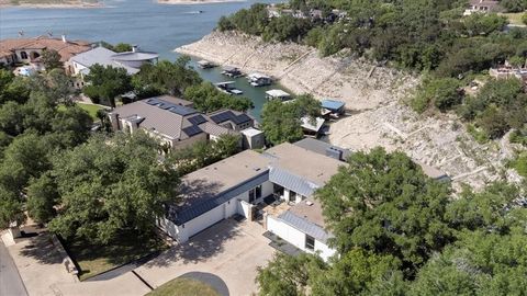 Spectacular COMPLETELY RENOVATED modern home sits on a Private protected cove of Lake Travis with captivating panoramic sunset views of Lake Travis! This breathtaking property offers modern design elements along with expansive open concept living are...