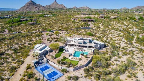 Indulge in the captivating beauty of this exquisite home, offering unparalleled sunset views and majestic mountain panoramas within an exclusive gated community! Upon entry, a picturesque courtyard welcomes you, setting the stage for an interior that...