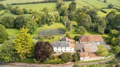 A fine period former farmhouse in just under 5 acres, set in magnificent, landscaped gardens with lake and tennis court and several outbuildings including 2 stables, a 2-storey office, three garages and further outbuildings with potential for further...
