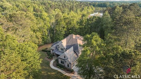 Wow! This is truly a remarkable property. Enter through the gates of the acclaimed Georgia Club community, located in the top rated Oconee County school system and then take a winding semi-private road to a wooded oasis enveloping a 7 Bedroom, 7 Bath...