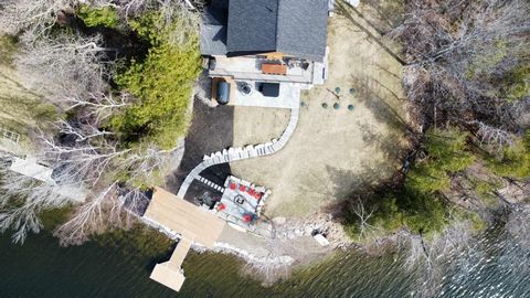 This stunning custom-built log home nestled on the shores, offers an unparalleled waterfront experience. Imagine tranquility and luxury with spectacular views from your professionally landscaped oasis boasting over 150 feet of pristine shoreline secu...