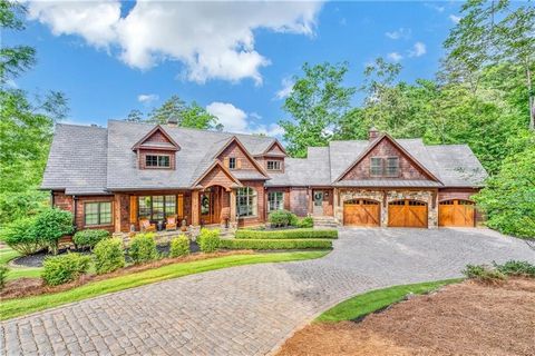 With an additional build site for a guest house, this incredible 2.56-acre, estate-sized property offers open water views of protected islands to the southwest, two natural sand beaches, and a magnificent home for life on Lake Keowee. A paver drivewa...